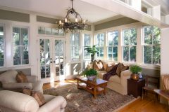 furnished sunroom with large windows and glass doors
