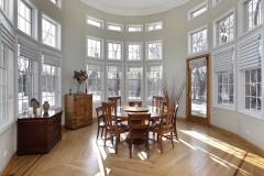 Sun room in luxury home with wall of windows